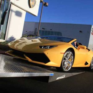 The Huracan glides up the custom extended ramps meant for lower nose cars.